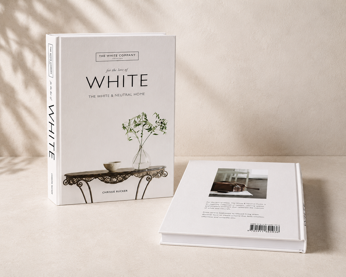 White Minimal decorative book styled on cream console table with ceramic vase