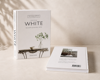 White Minimal decorative book styled on cream console table with ceramic vase
