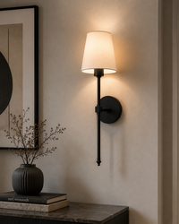 Black wireless wall sconce pair flanking console table luxury interior