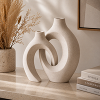 White sculptural ceramic vase set of 2 styled on warm sideboard with dried pampas grass